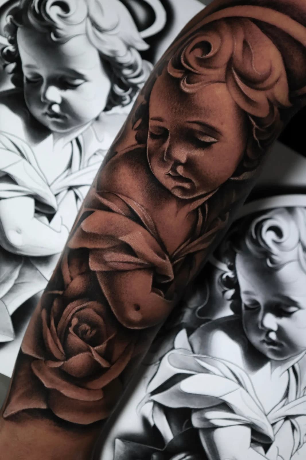 Cherub and rose sleeve tattoo
